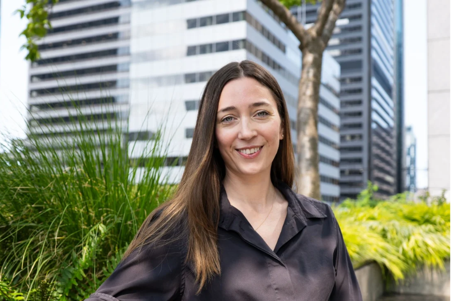 A photo of Amanda Snelson standing in front of a building on a sunny day