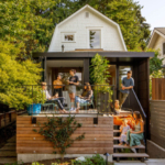 Exterior view of the Phinney Mini project, showcasing a contemporary architectural design with a distinctive facade featuring a mix of materials and large windows. The building is set in an urban environment, surrounded by greenery and pedestrian pathways. The design emphasizes functionality and aesthetic appeal, reflecting innovative concepts recognized by the 2022 Honor Awards.